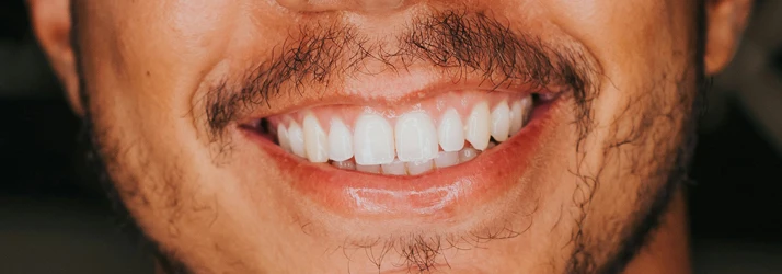 close up on a man with a stunning smile